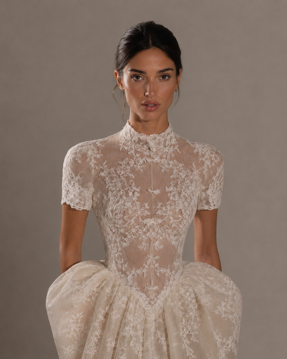 The Vintage — The old-money one. Chantilly lace from the high collar down, a nipped waist, and a full skirt that gathers at the hip and falls into a chapel train, handmade to order