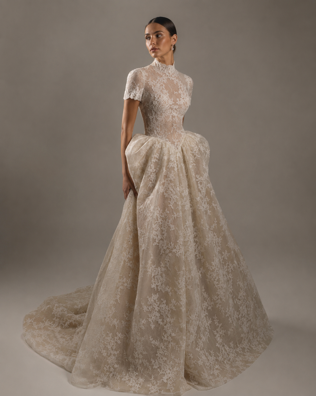 The Vintage — The old-money one. Chantilly lace from the high collar down, a nipped waist, and a full skirt that gathers at the hip and falls into a chapel train, made to measure